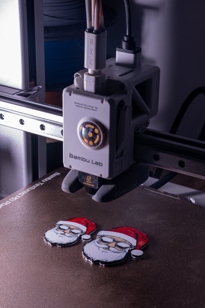 hero-img-02 3D printer crafting Santa Claus figures with red hats, capturing modern holiday manufacturing.