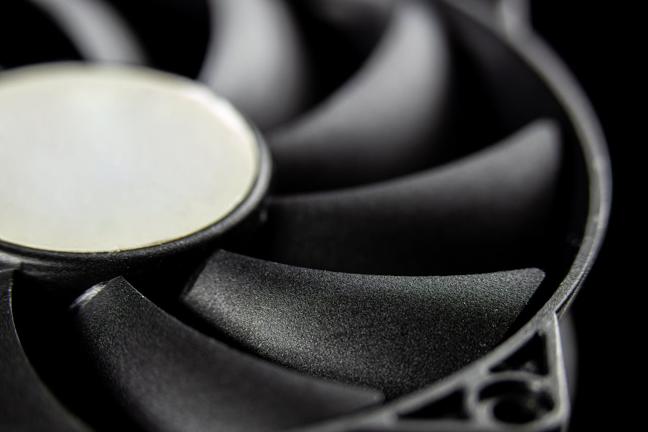 services-03 Macro close-up of a modern computer cooling fan blade, showcasing intricate details.