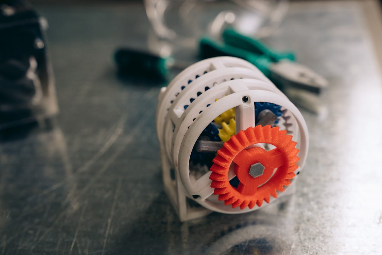 Mastering the First Impression: Your intriguing post title goes here A close-up photo of a 3D printed gear mechanism on a metallic workbench, highlighting innovation and technology.